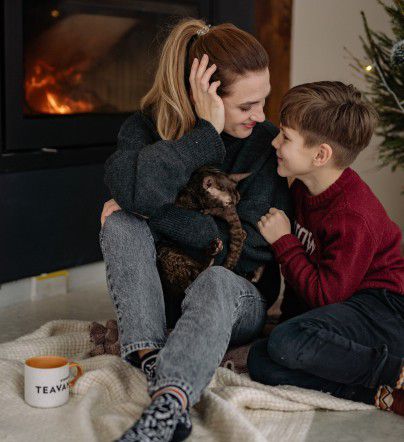 A mother and child by the fire